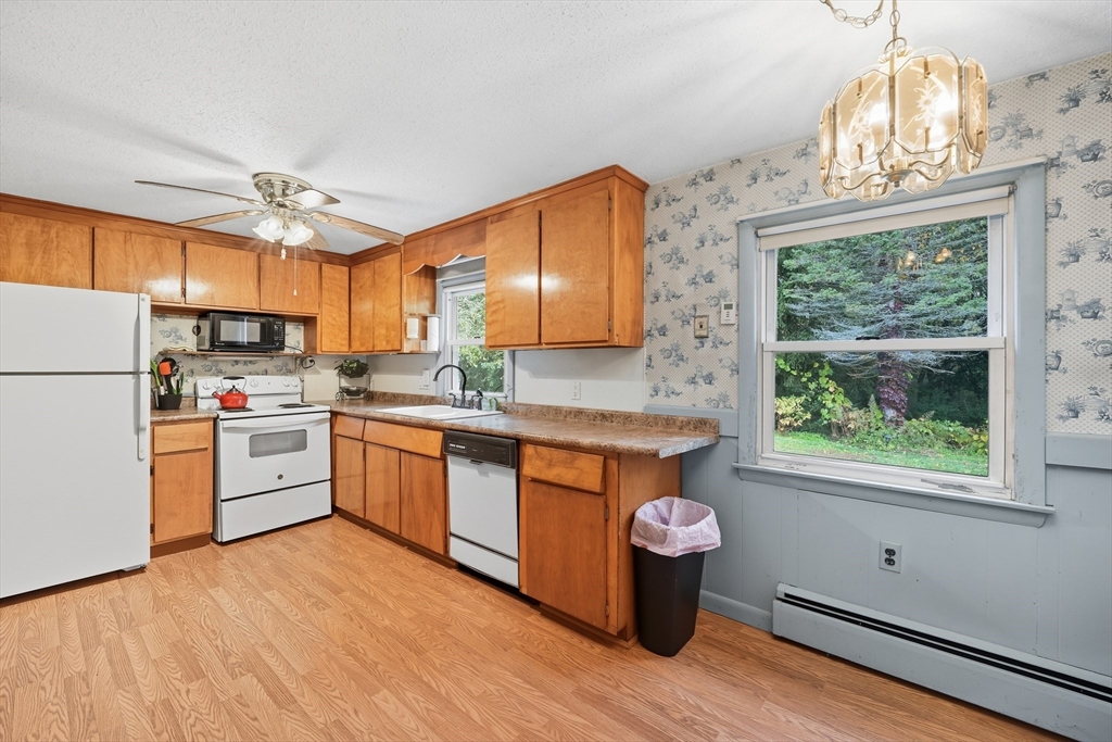 95 Meadowbrook Road Agawam, MA 01001 - Photo 23 of 39 a kitchen with a refrigerator a stove cabinets and wooden floor