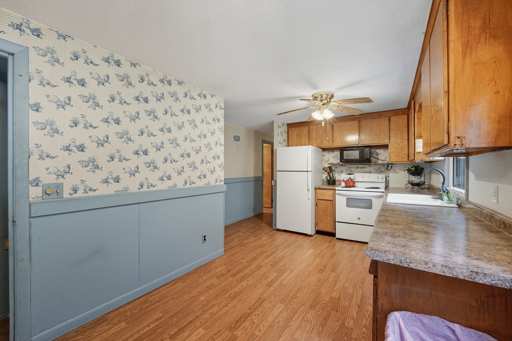 95 Meadowbrook Road Agawam, MA 01001 - Photo 24 of 39 a kitchen with granite countertop white cabinets and white appliances