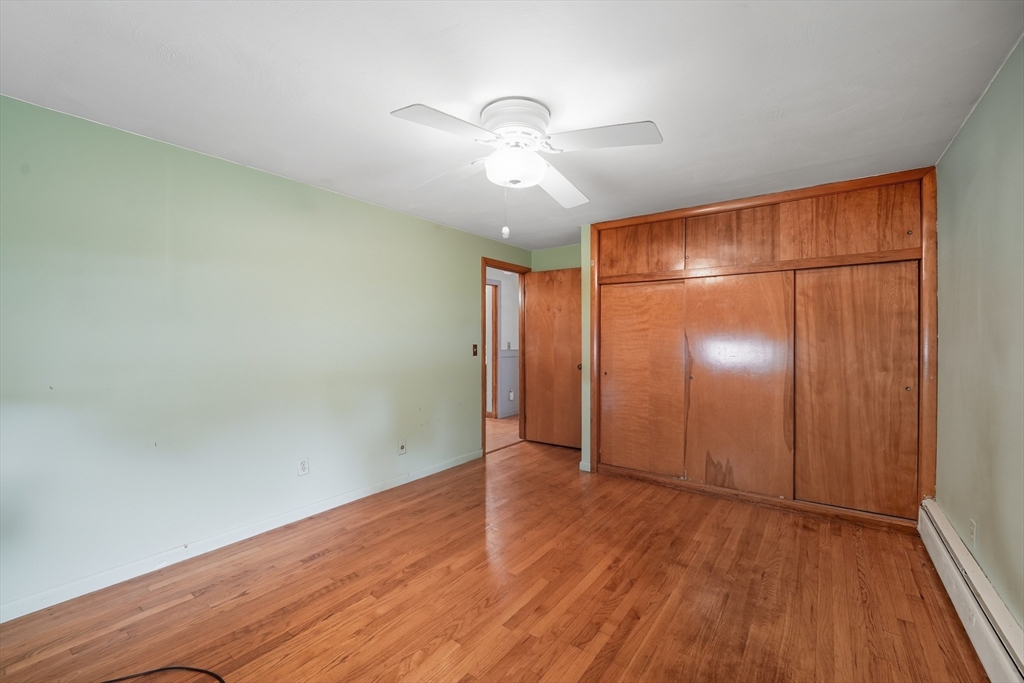 95 Meadowbrook Road Agawam, MA 01001 - Photo 8 of 39 an empty room with wooden floor fan and windows
