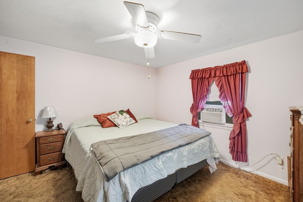 95 Meadowbrook Road Agawam, MA 01001 - Photo 10 of 39 a bedroom with a bed and a chandelier