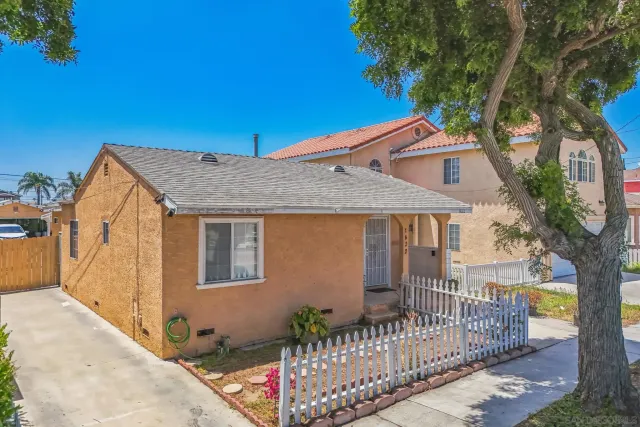 a front view of a house with wooden fence