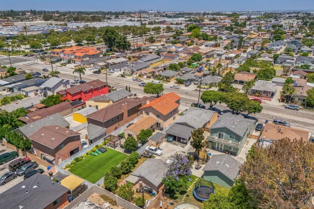 an aerial view of a houses with a yard