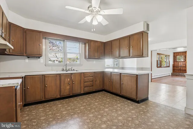 a kitchen with cabinets a sink and appliances