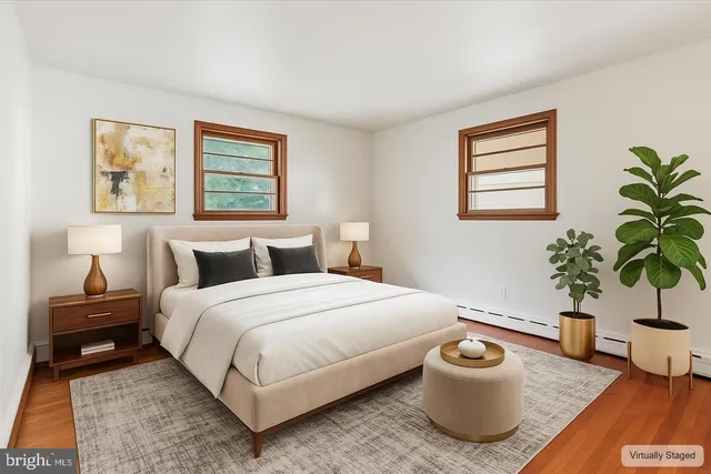 a bedroom with a bed and a potted plant