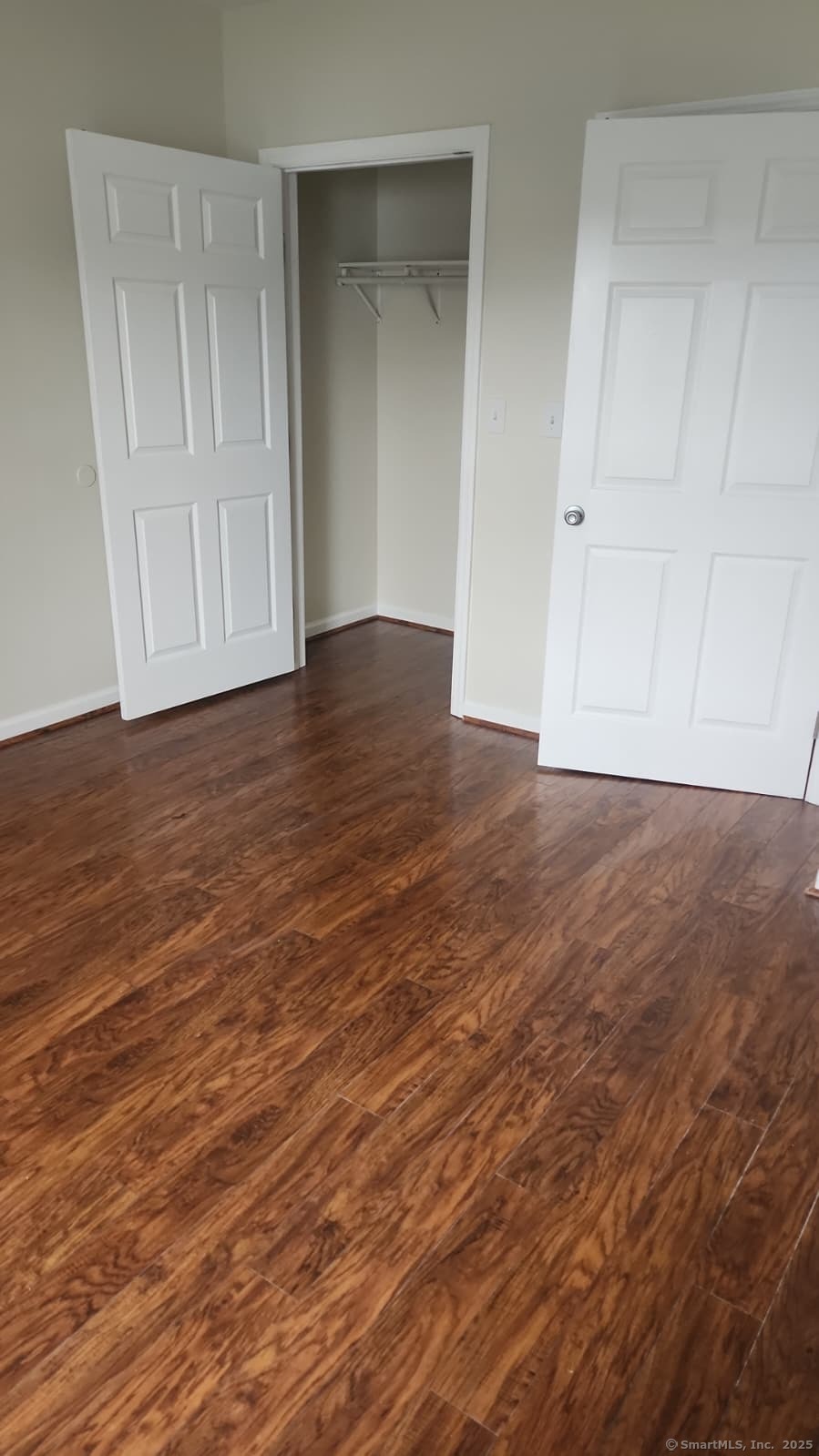 283 Waterview Avenue, Unit B Bridgeport, CT 06608 - Photo 2 of 7 a view of an empty room with closet and wooden floor