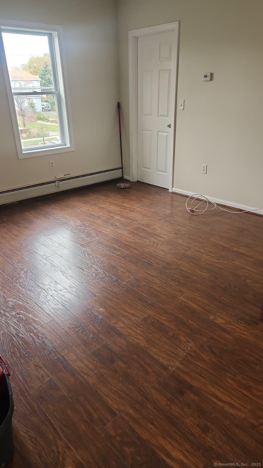 283 Waterview Avenue, Unit B Bridgeport, CT 06608 - Photo 6 of 7 an empty room with wooden floor and windows