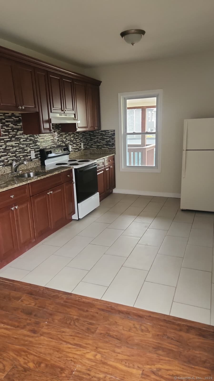 283 Waterview Avenue, Unit B Bridgeport, CT 06608 - Photo 7 of 7 a kitchen with stainless steel appliances granite countertop a stove a sink and a microwave