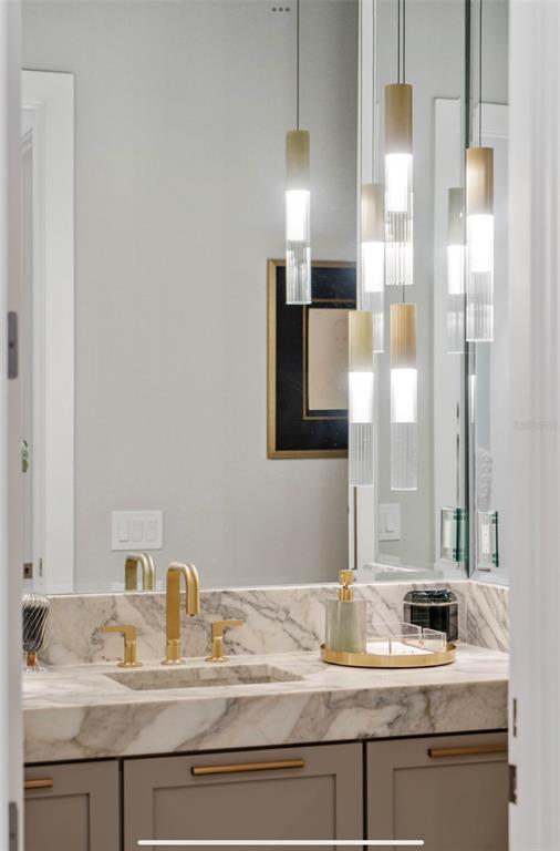 4923 West San Rafael Street Tampa, FL 33629 - Photo 35 of 70 a bathroom with a granite countertop sink and a mirror