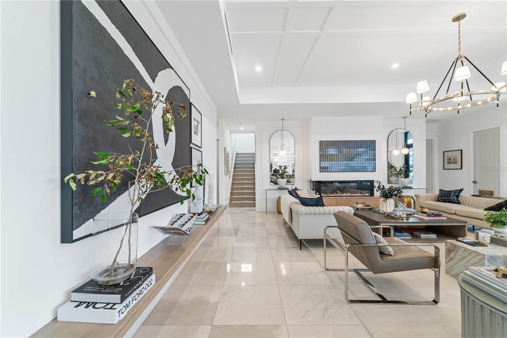 4923 West San Rafael Street Tampa, FL 33629 - Photo 52 of 70 a living room with furniture a chandelier and a flat screen tv