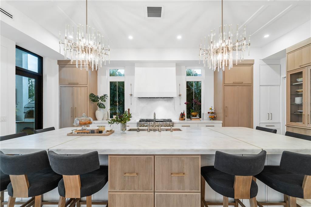 4923 West San Rafael Street Tampa, FL 33629 - Photo 55 of 70 a view of a dining room with furniture a chandelier and wooden floor