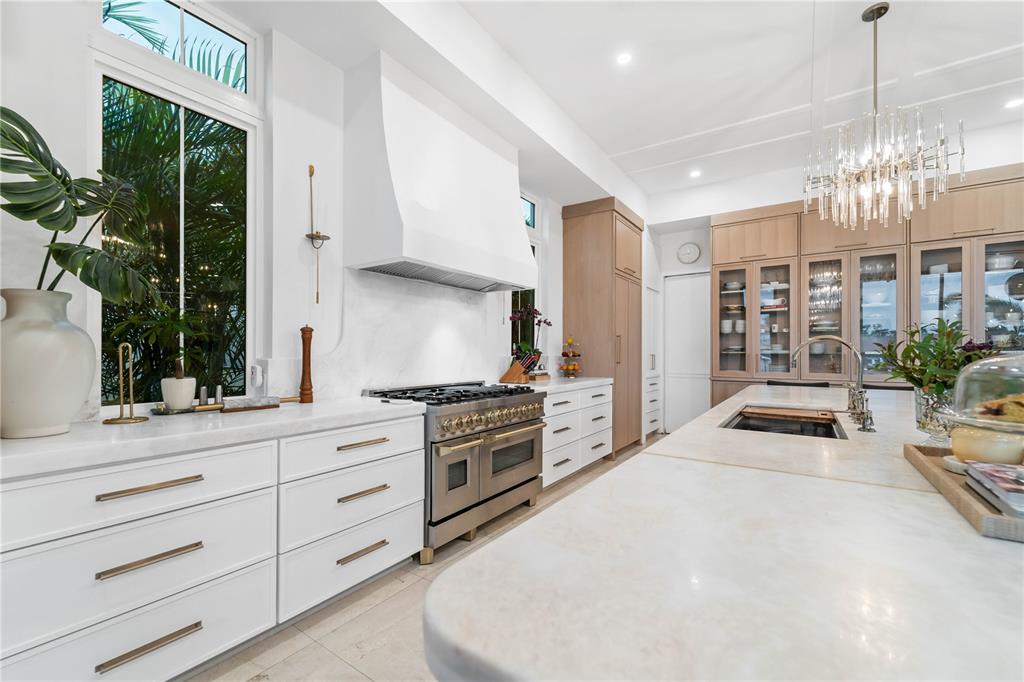 4923 West San Rafael Street Tampa, FL 33629 - Photo 66 of 70 a kitchen with granite countertop a stove and a chandelier