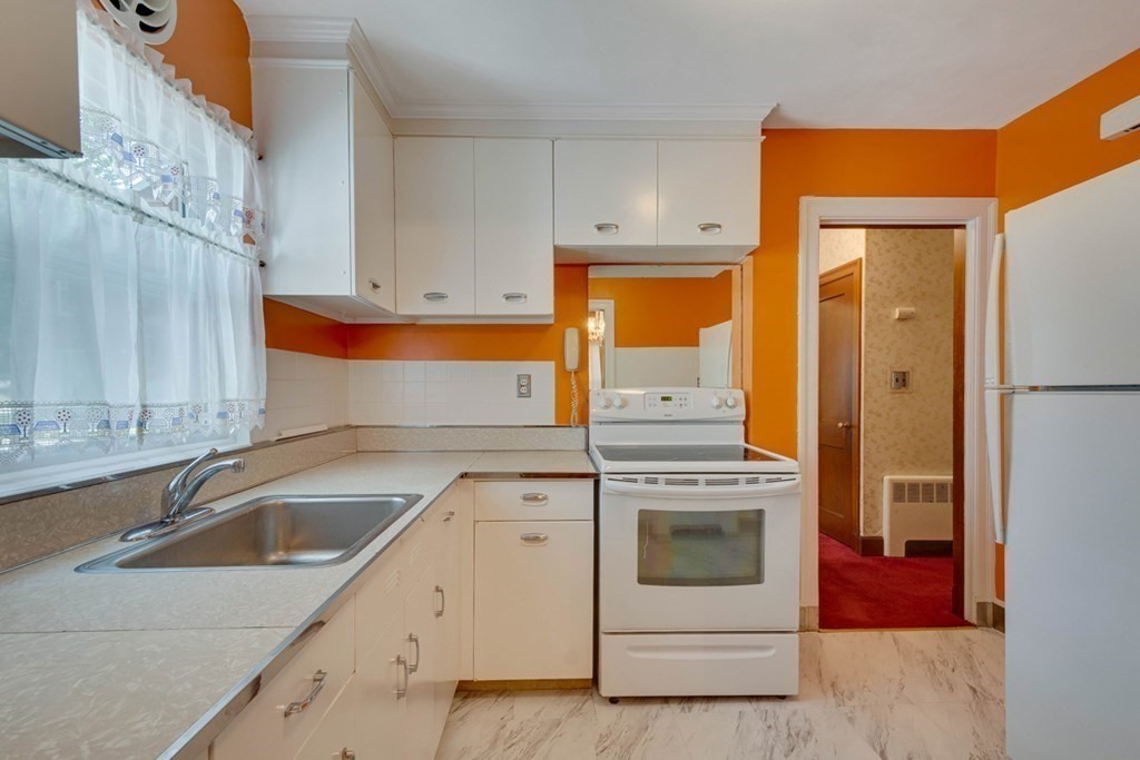 11 Stimson Street Boston, MA 02132 - Photo 11 of 32 a kitchen with a stove oven and sink