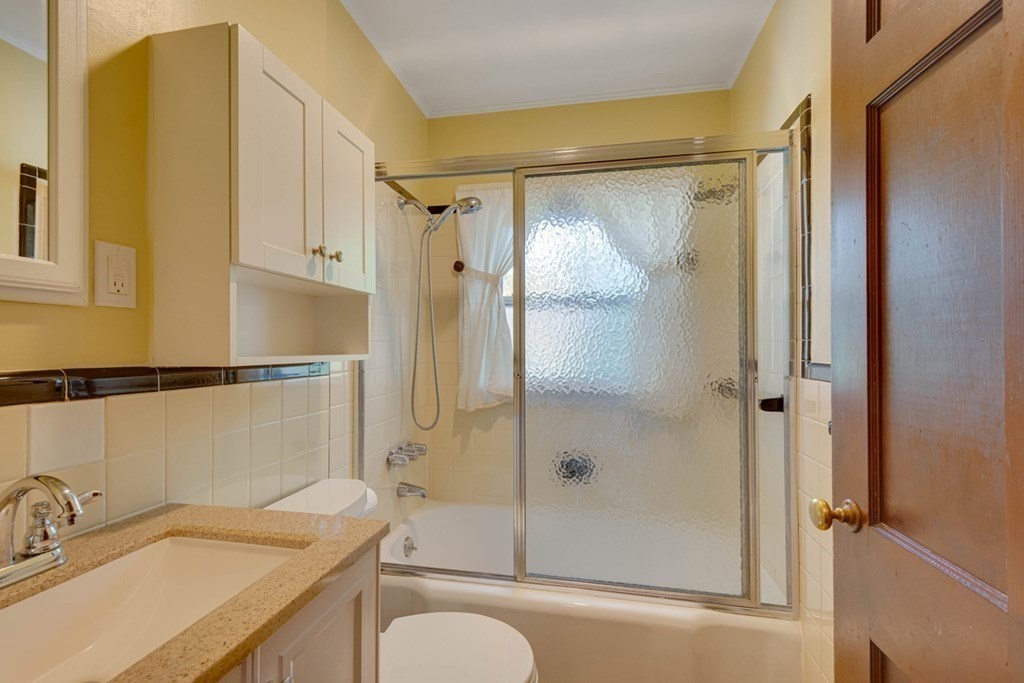11 Stimson Street Boston, MA 02132 - Photo 16 of 32 a bathroom with a granite countertop sink toilet and shower