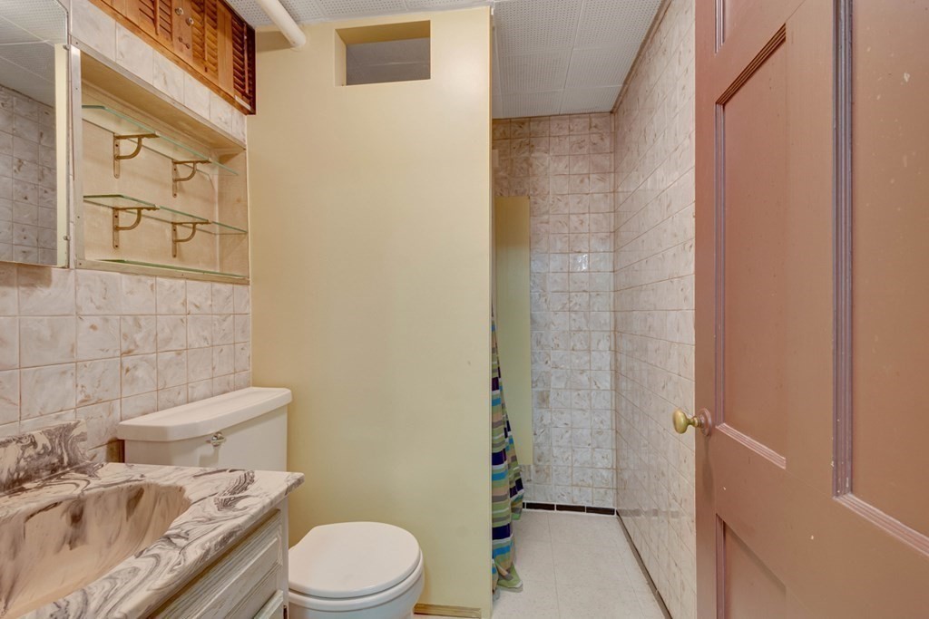 11 Stimson Street Boston, MA 02132 - Photo 27 of 32 a white toilet sitting next to a bathroom sink