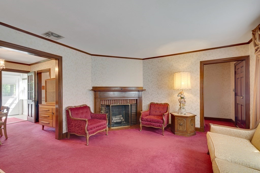 11 Stimson Street Boston, MA 02132 - Photo 8 of 32 a living room with furniture and a fireplace