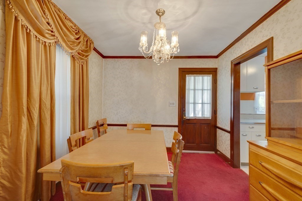 11 Stimson Street Boston, MA 02132 - Photo 9 of 32 a bed room with a bed and a chandelier