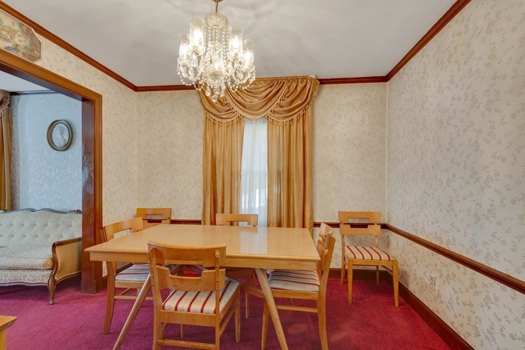 11 Stimson Street Boston, MA 02132 - Photo 10 of 32 a view of a dining room with furniture and chandelier