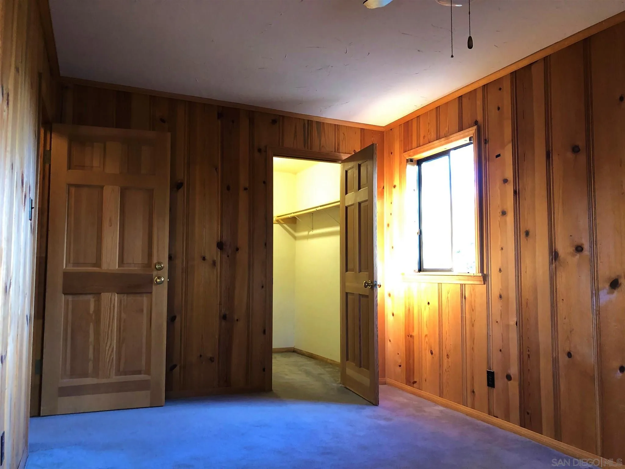 4824 Pine Ridge Way Julian, CA 92036 - Photo 18 of 25 an empty room with wooden floor and a window