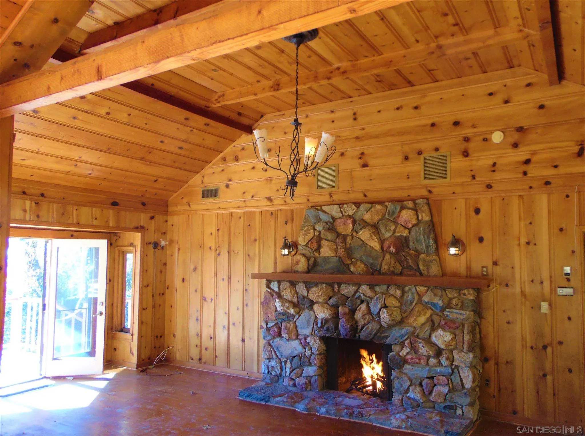4824 Pine Ridge Way Julian, CA 92036 - Photo 8 of 25 a room with wooden floor and a fireplace