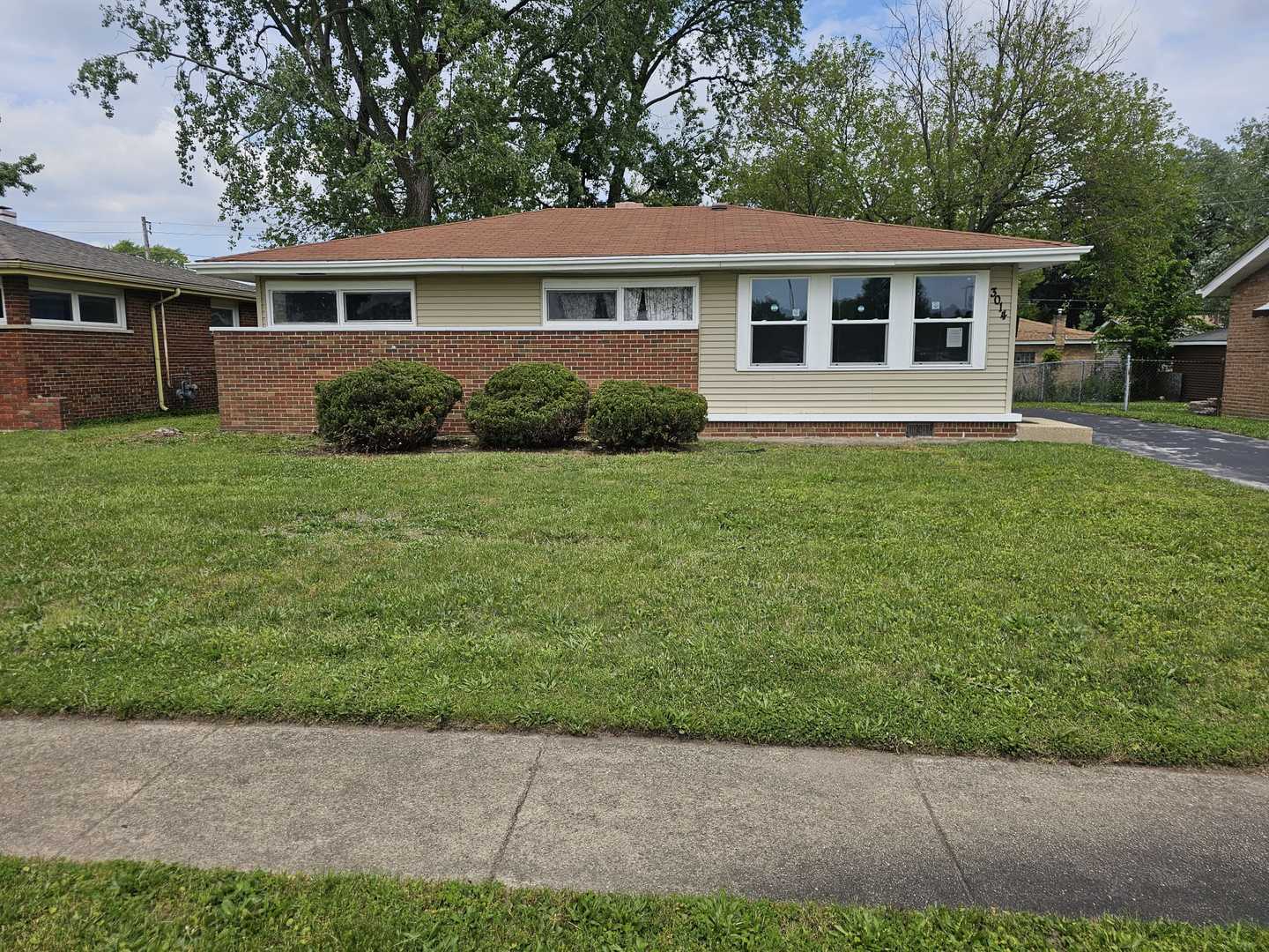 3014 West 163rd Street Markham, IL 60428 - Photo 1 of 18 a front view of a house with a yard