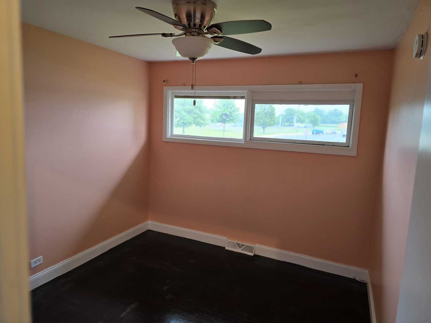 3014 West 163rd Street Markham, IL 60428 - Photo 15 of 18 an empty room with a window and a ceiling fan