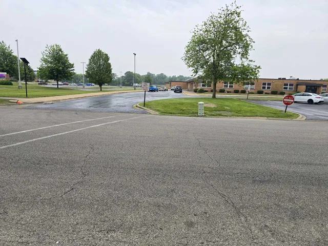 a view of outdoor space with playground and green space