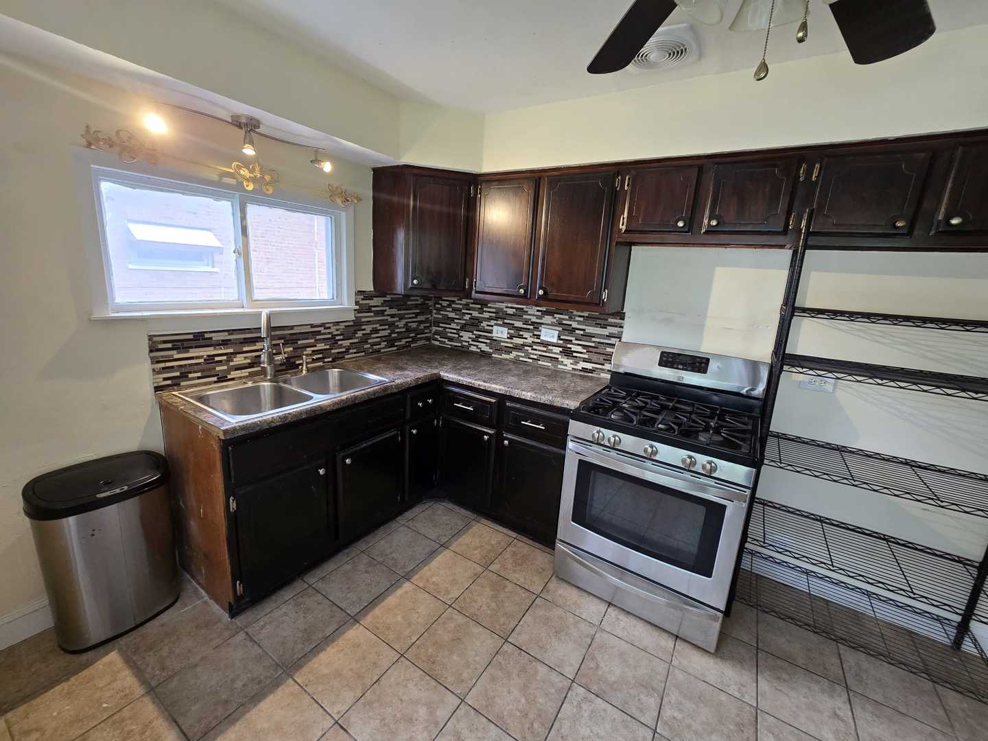 3014 West 163rd Street Markham, IL 60428 - Photo 5 of 18 a kitchen with a sink and a stove top oven