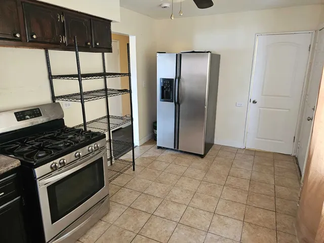 a kitchen with granite countertop a stove and a refrigerator