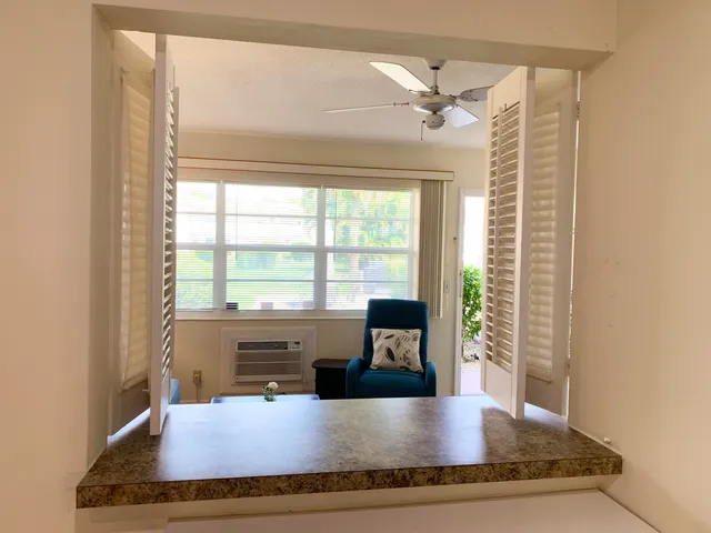 a view of kitchen with granite countertop a sink and a stove