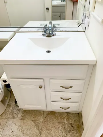 a bedroom with a bed couch and a window