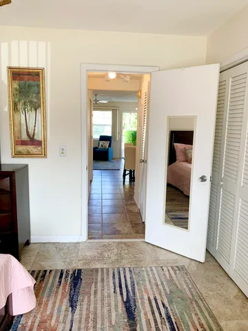a view of hallway with stairs and furniture
