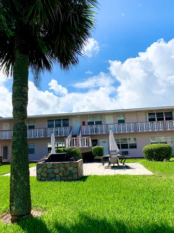 a view of a house with swimming pool and sitting area