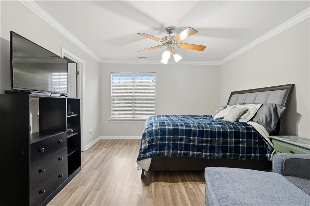 2664 Reston Court Northwest Kennesaw, GA 30144 - Photo 14 of 28 a bedroom with a bed and a flat tv screen on dresser