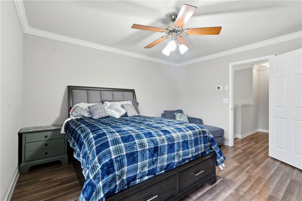 2664 Reston Court Northwest Kennesaw, GA 30144 - Photo 15 of 28 a bedroom with a bed and a chandelier