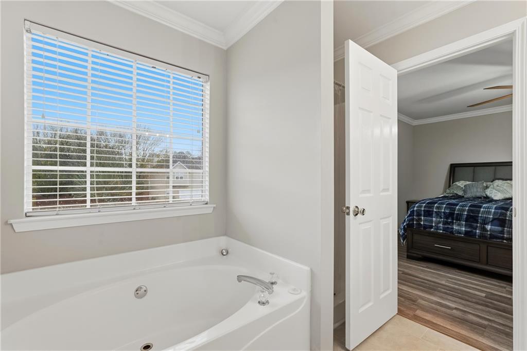 2664 Reston Court Northwest Kennesaw, GA 30144 - Photo 16 of 28 a bathroom with a bathtub and a shower