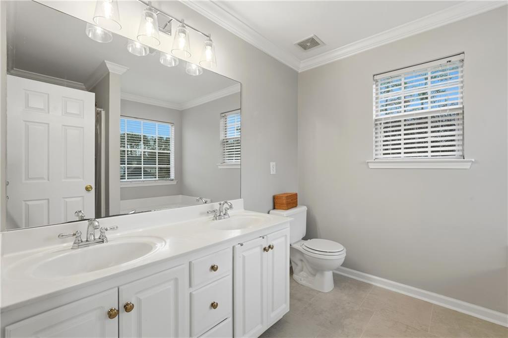 2664 Reston Court Northwest Kennesaw, GA 30144 - Photo 17 of 28 a bathroom with a double vanity sink toilet and a mirror