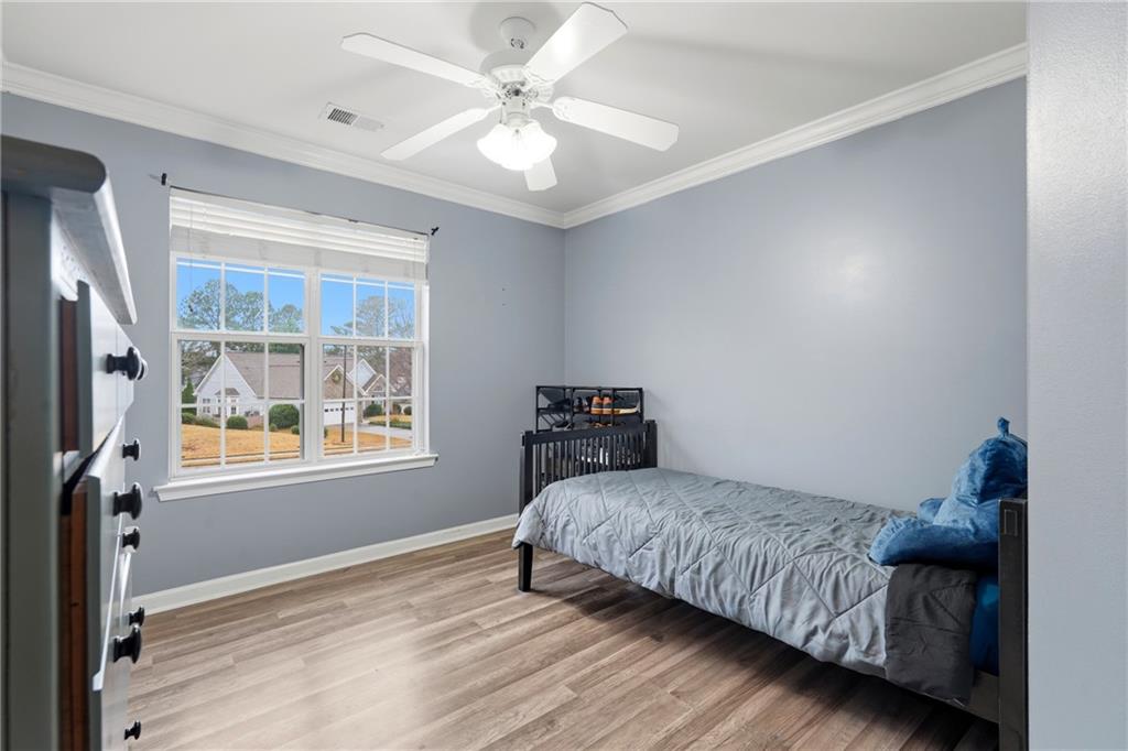 2664 Reston Court Northwest Kennesaw, GA 30144 - Photo 18 of 28 a bedroom with a bed and a window