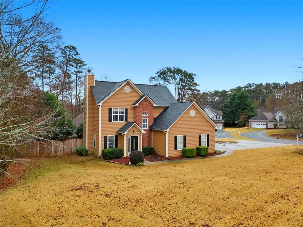 2664 Reston Court Northwest Kennesaw, GA 30144 - Photo 2 of 28 a view of a white house with a yard and large tree