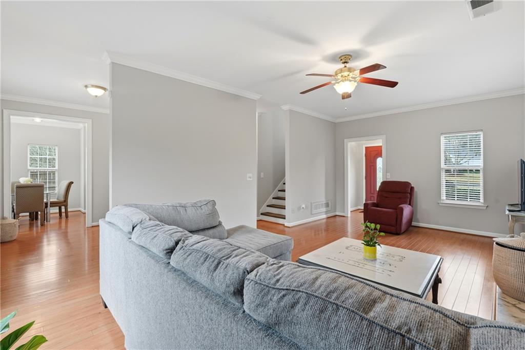 2664 Reston Court Northwest Kennesaw, GA 30144 - Photo 7 of 28 a living room with furniture and wooden floor