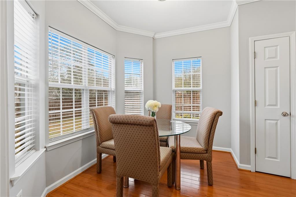 2664 Reston Court Northwest Kennesaw, GA 30144 - Photo 9 of 28 a view of a dining room with furniture and wooden floor