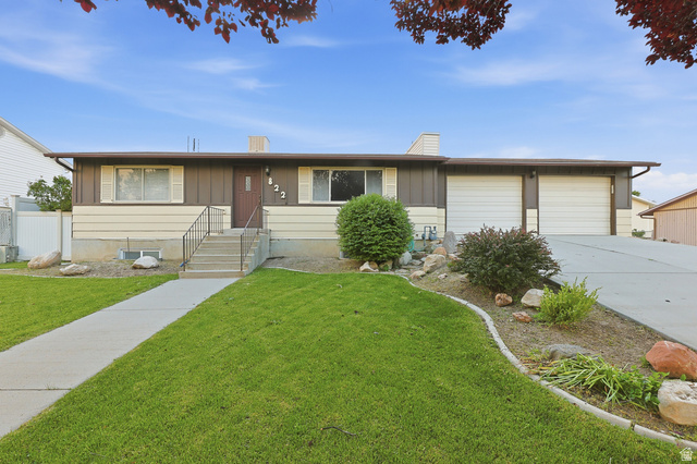 822 Pinewood Circle Price, UT 84501 - Photo 1 of 49 Ranch-style residence featuring a two-tone exterior, a concrete walkway leading to the front entry, a two-car garage, and established landscaping with decorative rocks