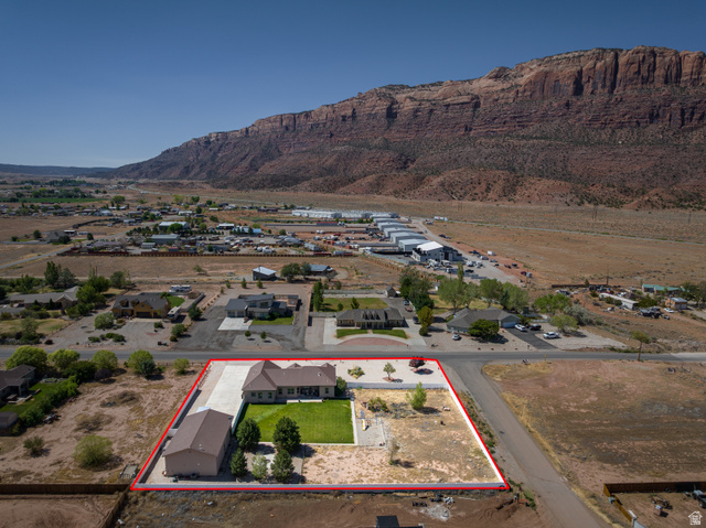 4635 East Sunny Acres Lane Moab, UT 84532 - Photo 4 of 56 Single-story residence featuring a private driveway, detached garage structure, and manicured lawn