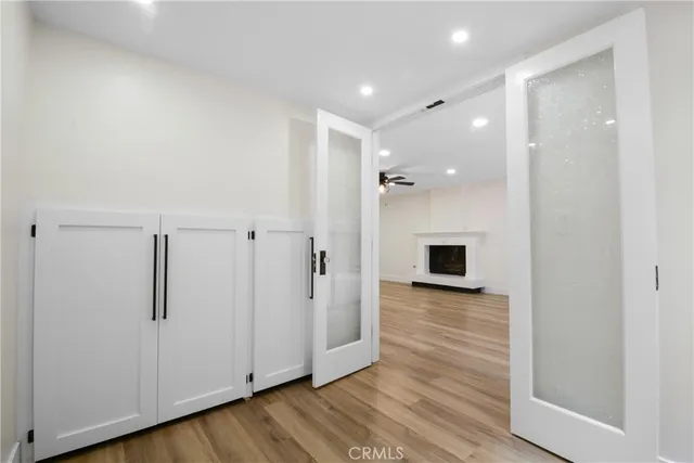 a view of a hallway with wooden floor