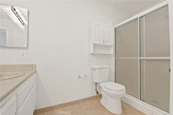 a white toilet sitting next to a bathroom sink