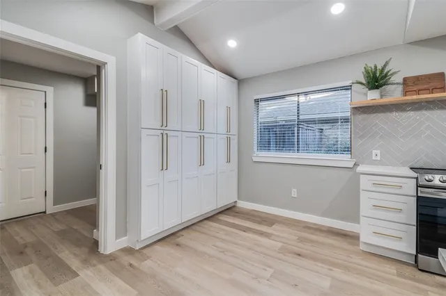 a kitchen with a stove a sink and a refrigerator
