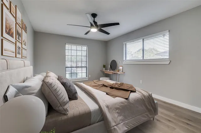 a bathroom with a toilet sink vanity and mirror