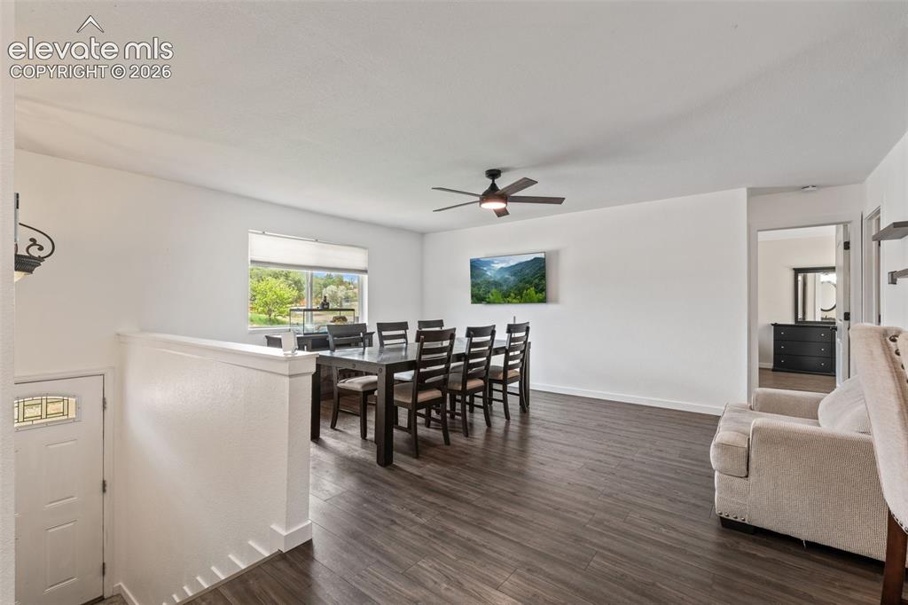 125 Diamond E Road Fountain, CO 80817 - Photo 9 of 43 a view of a dining room with furniture and wooden floor
