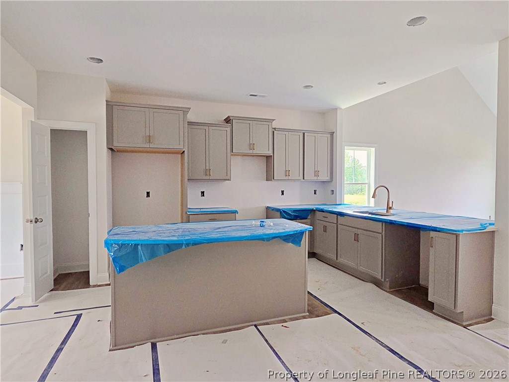 2678 Norrington Road Lillington, NC 27546 - Photo 7 of 31 a kitchen with stainless steel appliances granite countertop a sink and cabinets