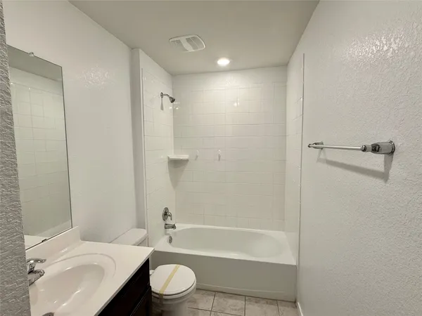 a bathroom with a toilet a sink and bathtub