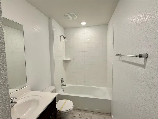 a bathroom with a toilet a sink and bathtub